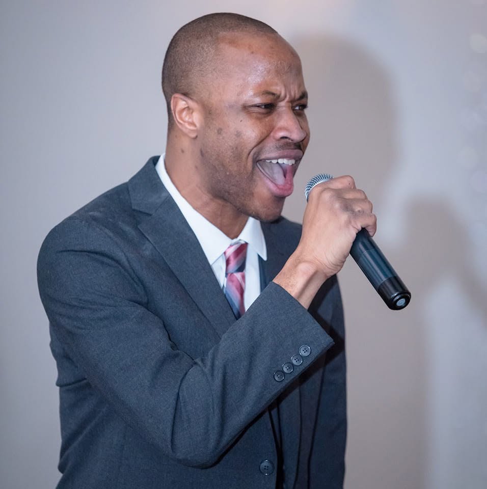 Elegant singer performing at a special event with a microphone